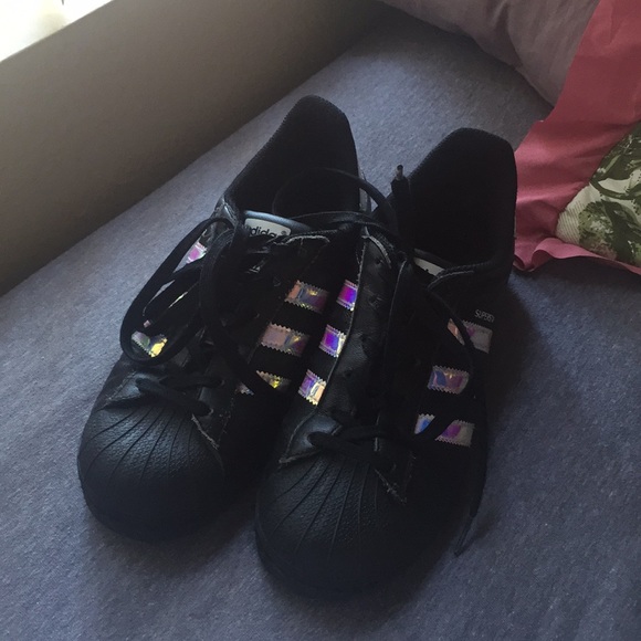 black adidas with iridescent stripes